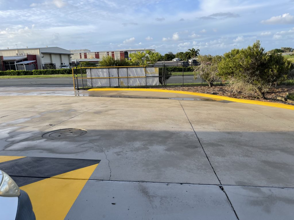 Commercial driveway before pressure cleaning