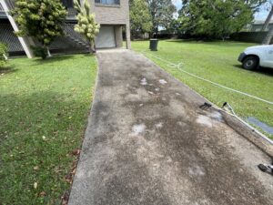 Dirty concrete driveway before driveway cleaning in Andergrove