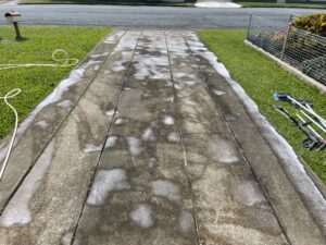 Concrete driveway pre-treatment before pressure washing in Mackay