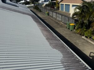 Before and after roof cleaning showing mould removal on Colorbond roof in East Mackay
