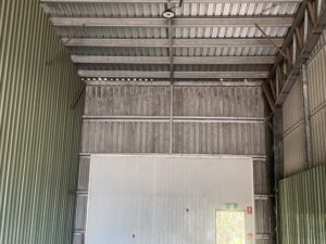 Dirty industrial shed wall before cleaning Mackay