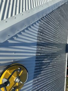 Professional roof cleaning equipment removing mould from Colorbond roof in East Mackay