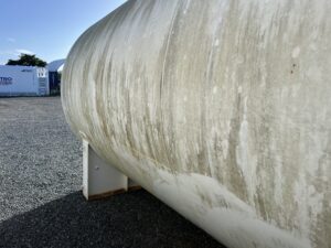  Dirty industrial storage tank covered in mould and grime before soft washing in Paget Mackay
