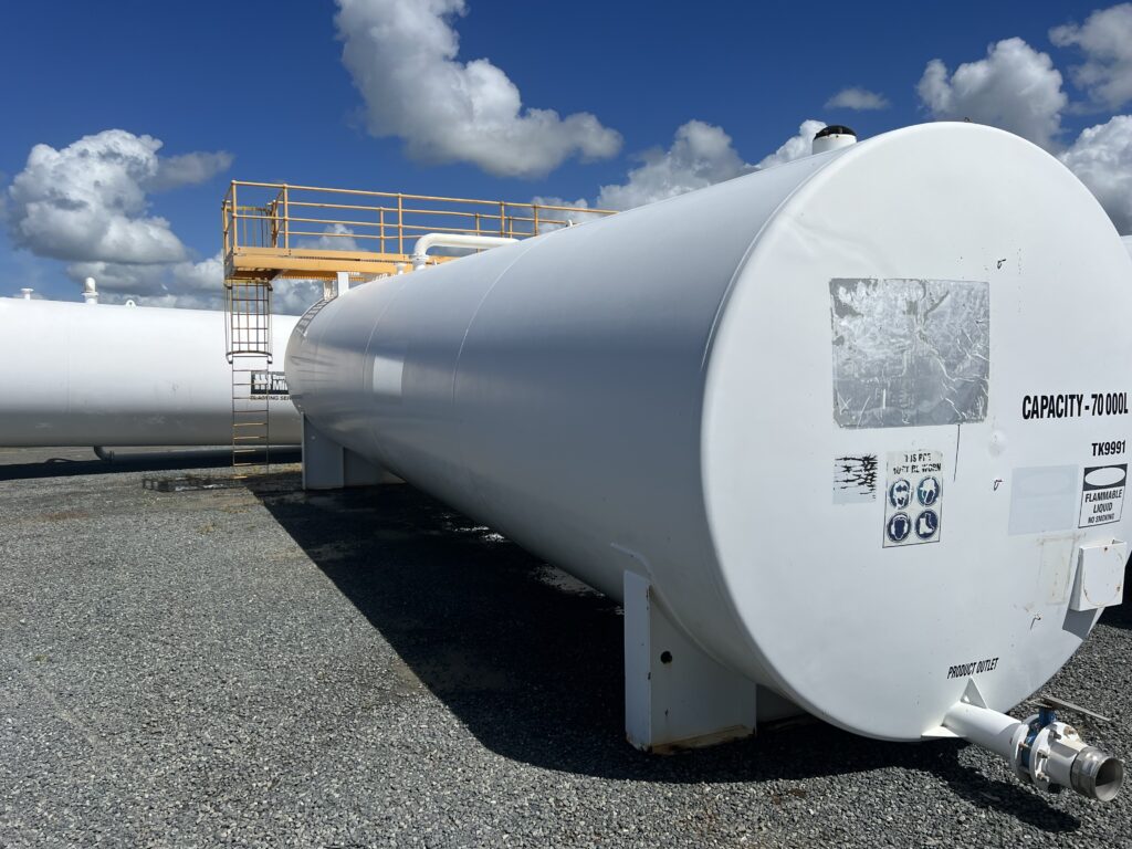 Clean white industrial fuel storage tank after soft washing and exterior cleaning in Paget Mackay