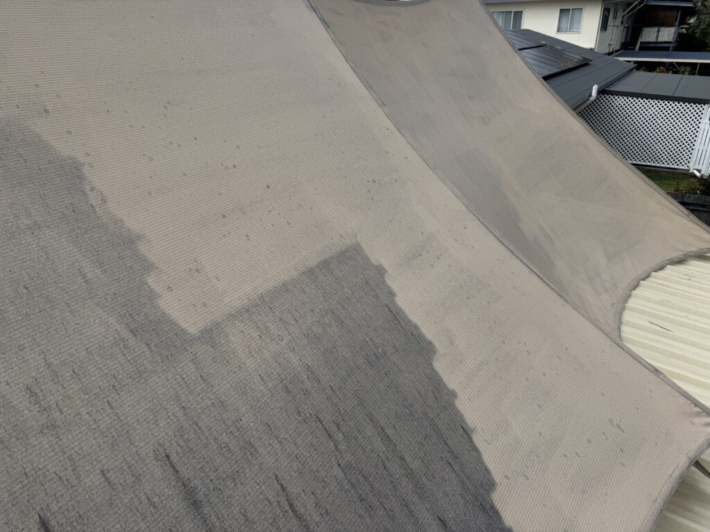 Before and after shade sail clean in South Mackay showing mould removal