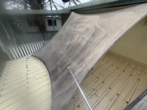 Low pressure washing of mouldy shade sail in Mackay