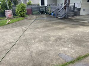 Dirty concrete driveway before pressure cleaning service in East Mackay