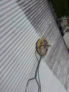 Professional roof cleaning equipment cleaning a Colorbond roof in Glenella Mackay