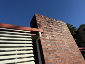 Brick exterior staining and mould build-up on commercial building in Mackay