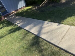 Clean exterior wall and driveway after soft washing in Mackay