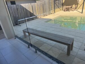 Glass pool fence cleaned during exterior cleaning service in Glenella
