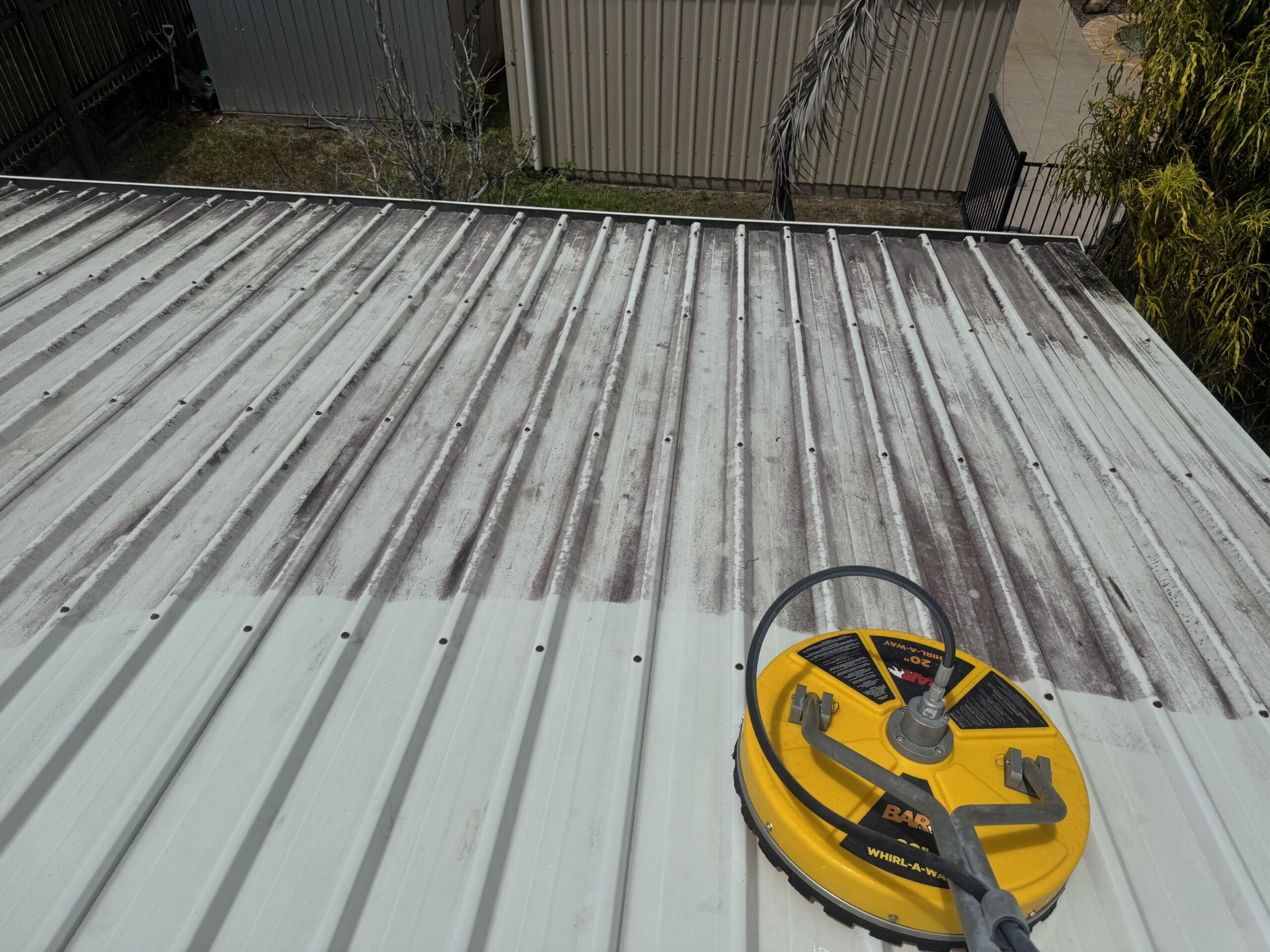 Pristine Washing cleaning a Colorbond roof in Glenella