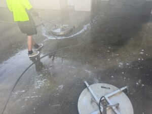 Team member rinsing the entrance.
