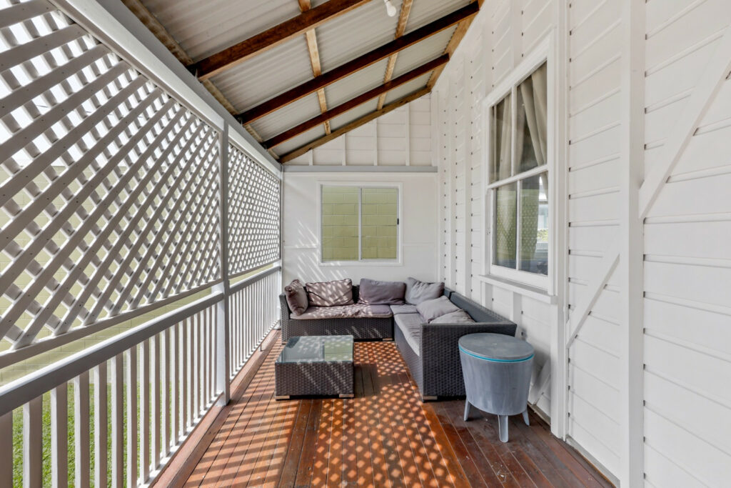 Timber verandah with white lattice screening and seating, illustrating our timber deck cleaning before oiling guide