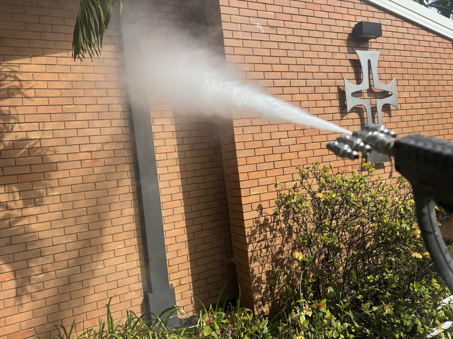 Pristine Washing washing an exterior brick wall during the St Mary's school cleaning project