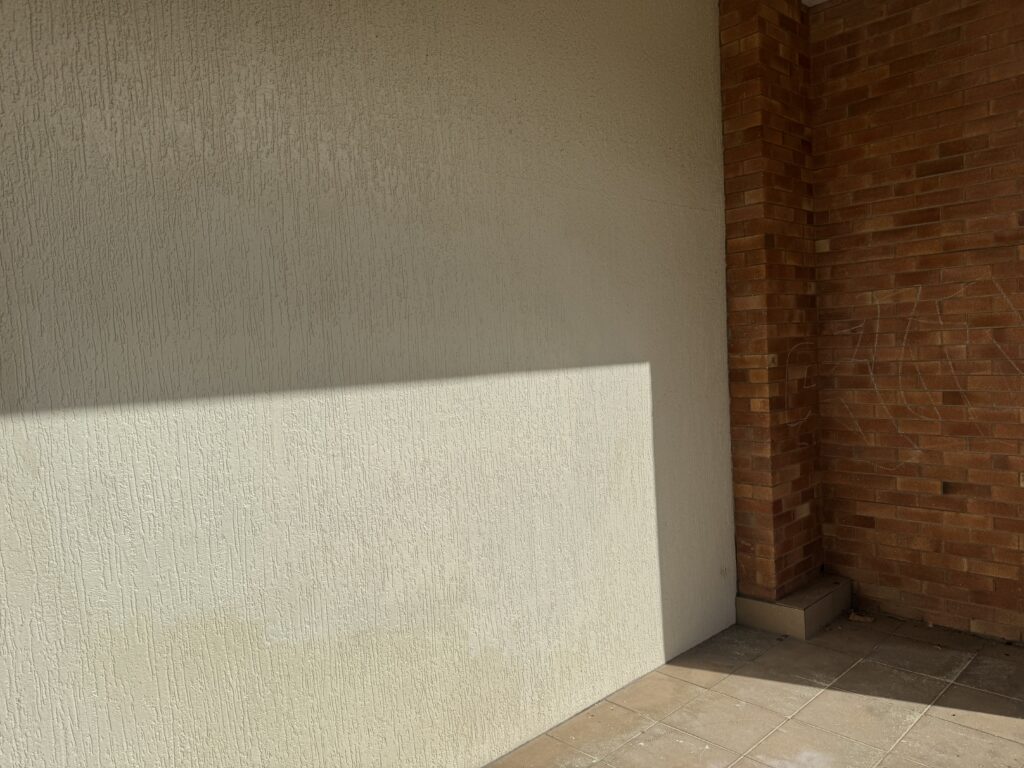 Cream textured wall after graffiti removal from buildings in Mackay