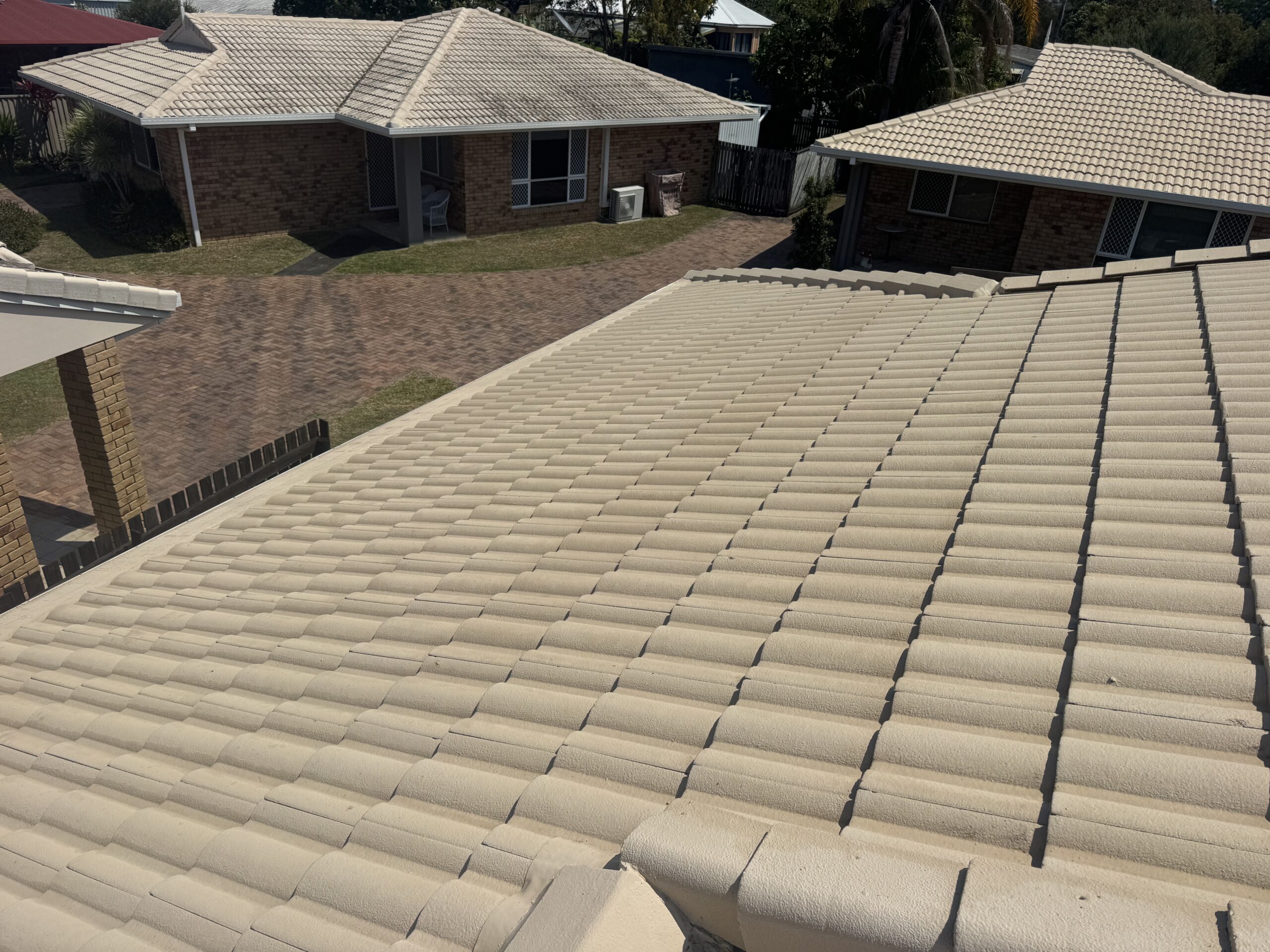 Light beige painted roof tiles after cleaning in West Mackay