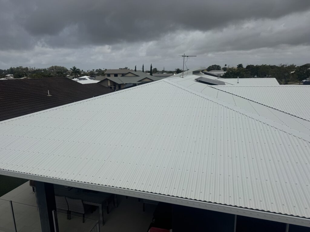 Cleaned light-coloured metal house roof in Glenella after cleaning by Pristine Washing